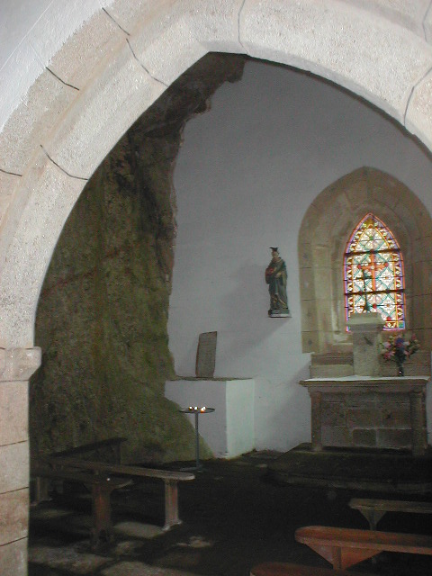 interior of old building with a stone arch in middle