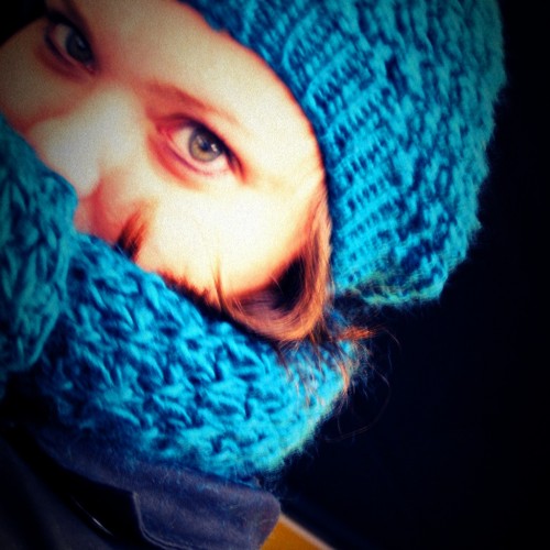 a person in a blue hat that is wearing knitted