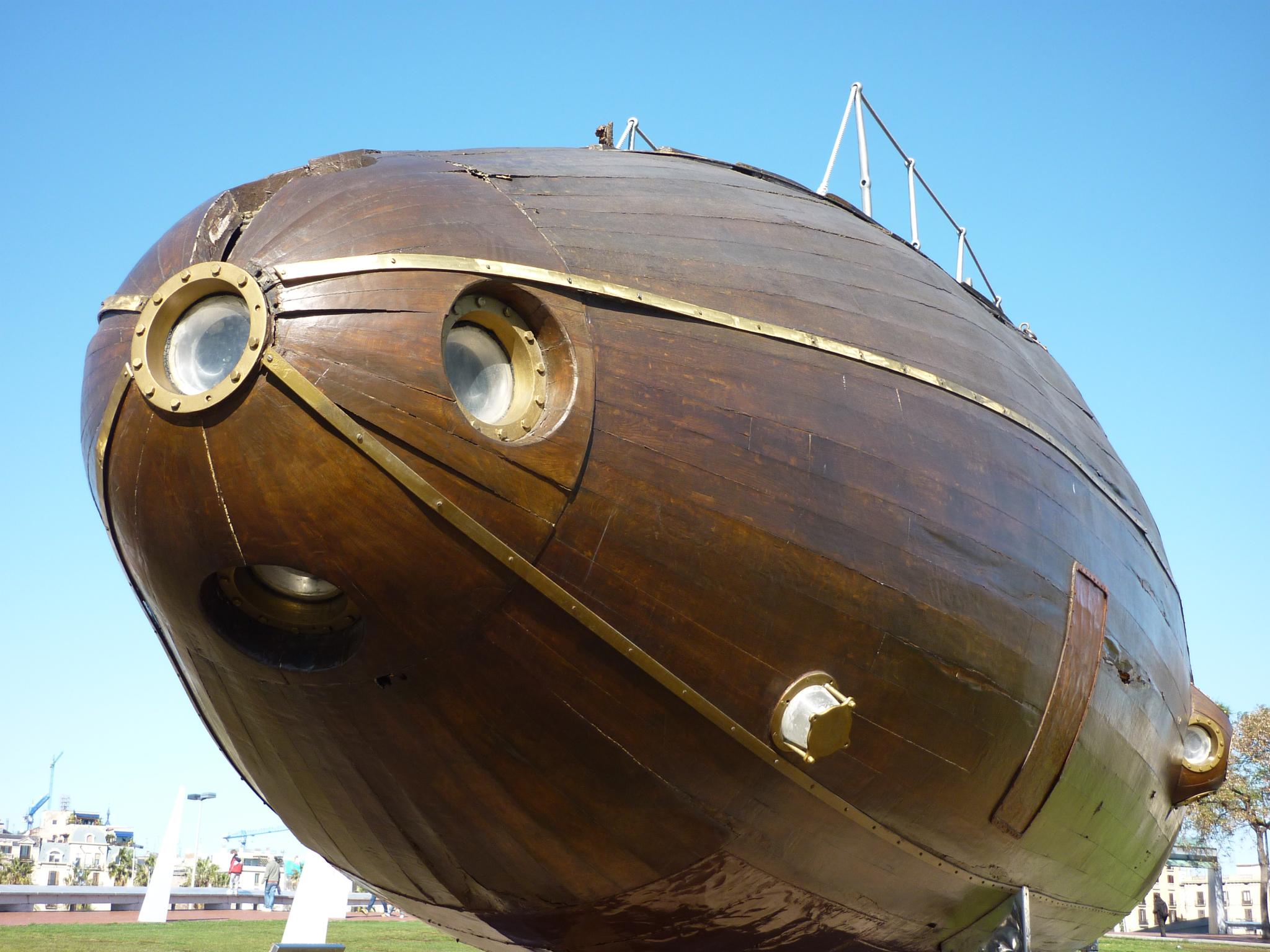 a giant wooden ship is outside by the grass