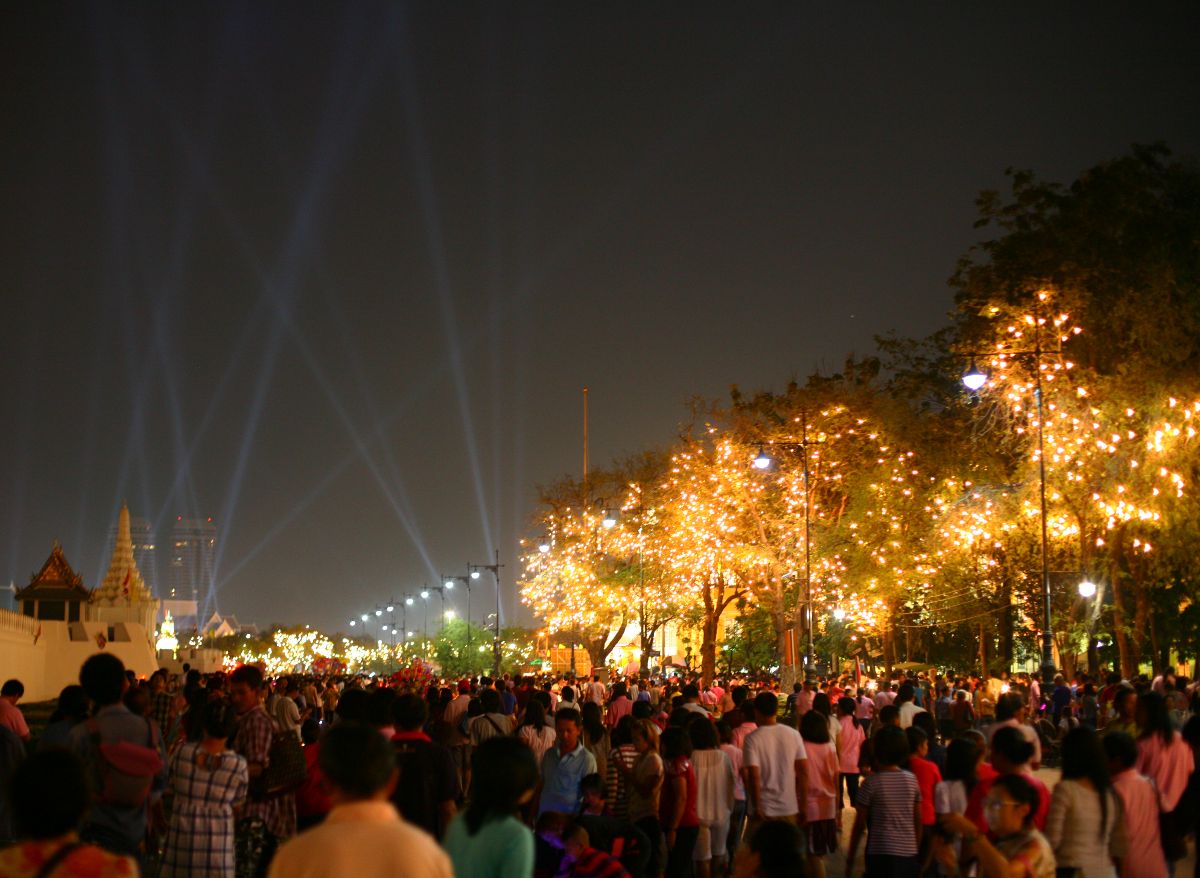 a crowd of people standing around at night