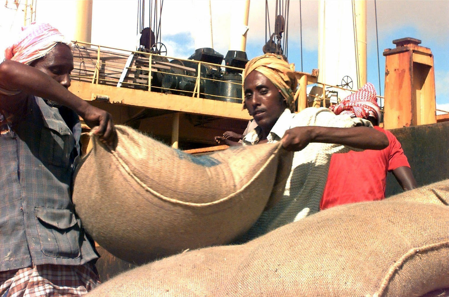 people on a boat with a blanket over their heads