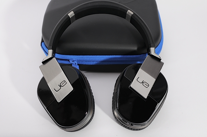 black headphones on the case with a logo on them