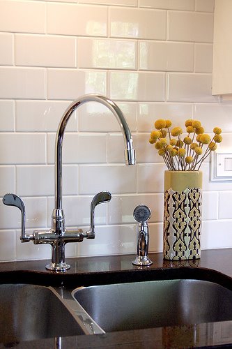 a sink and some flowers in a vase