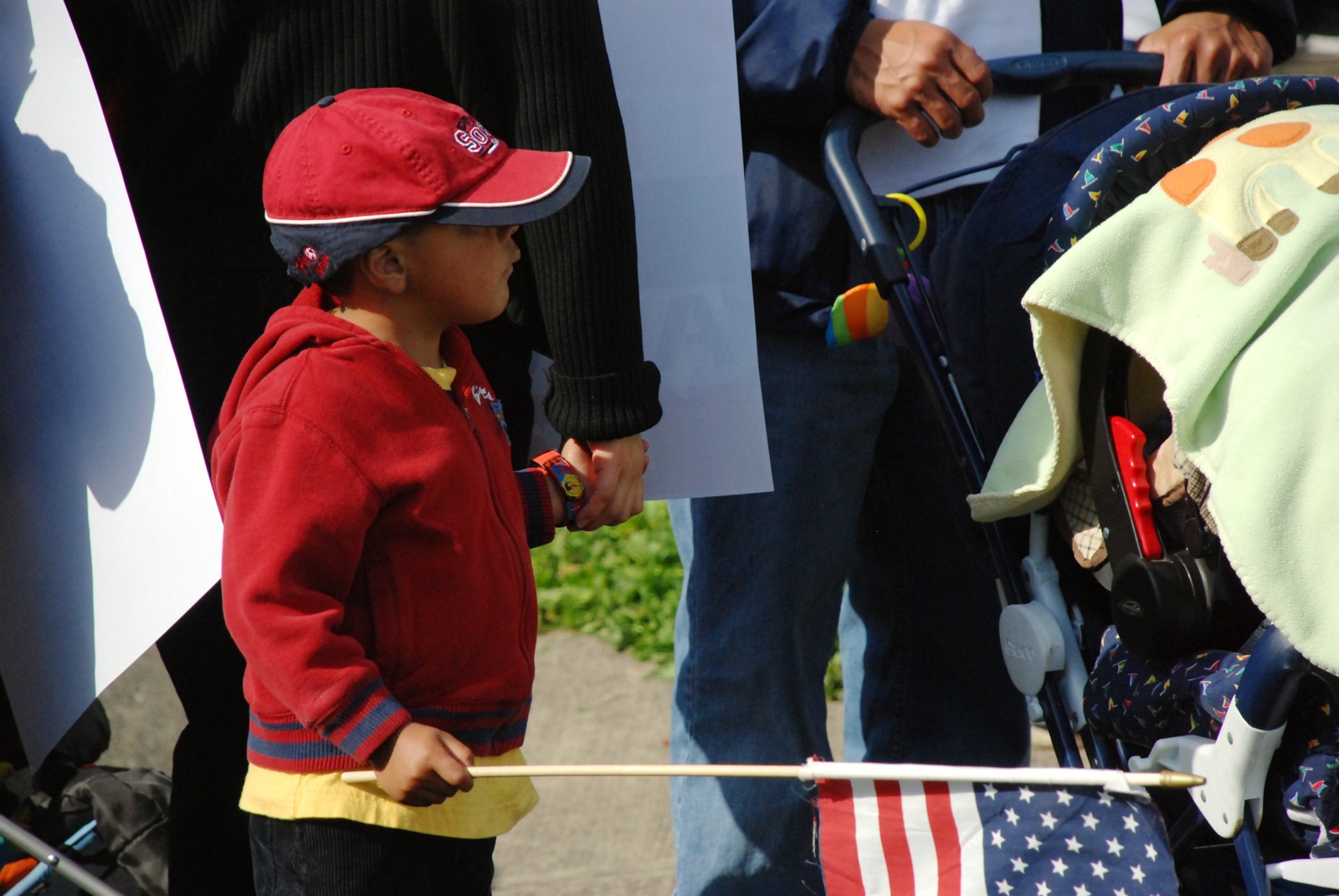 a little boy standing next to his fathers flags