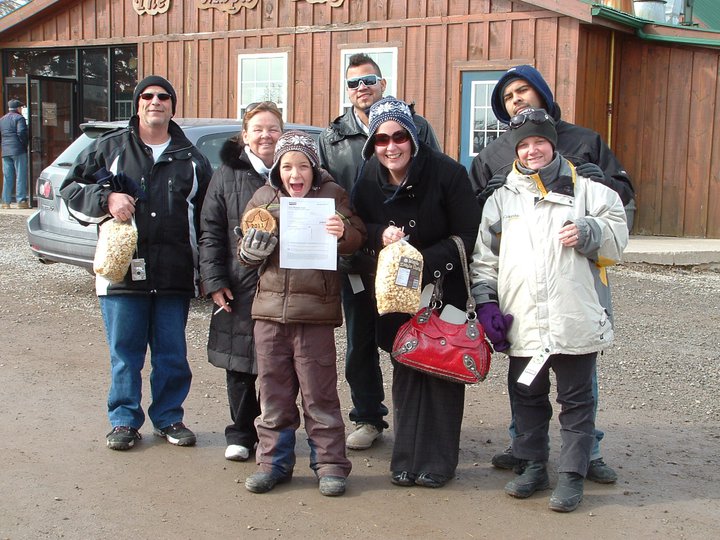 a group of people posing for a picture outside a lodge