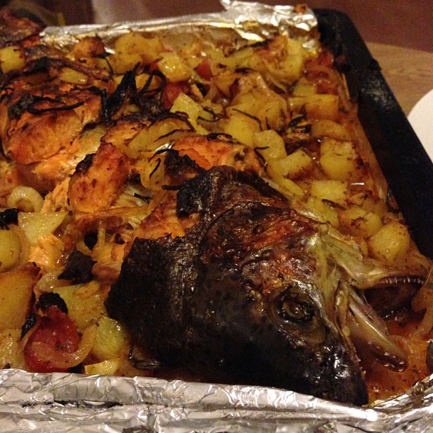 the roast has been cooked with potatoes and meat