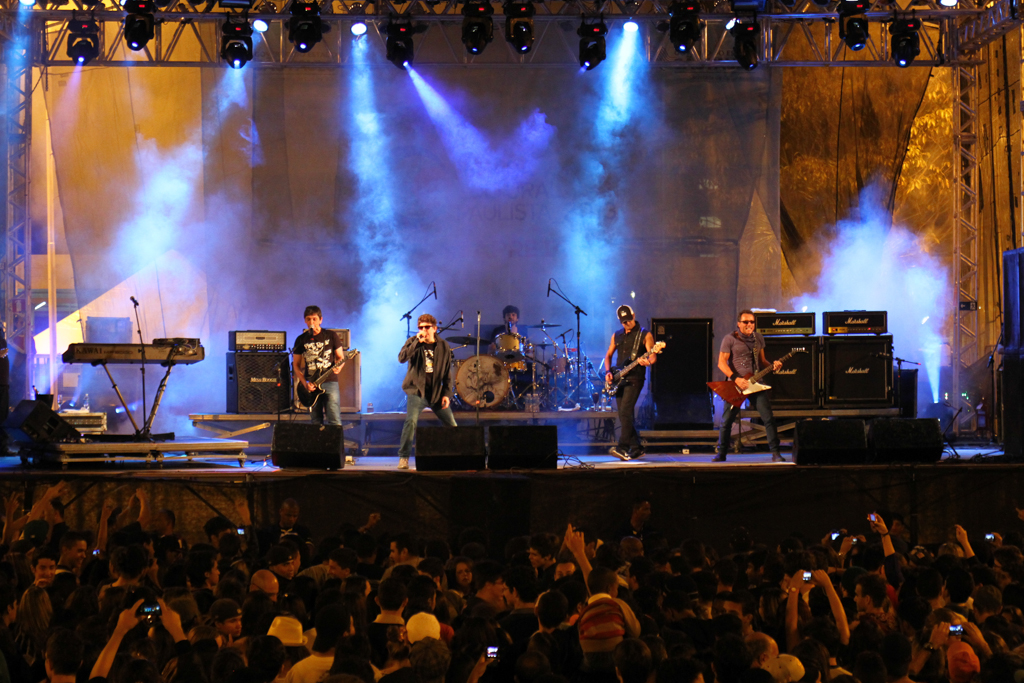 group of people on stage performing at outdoor concert