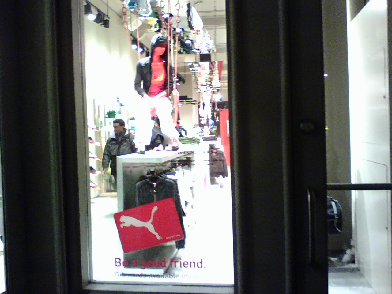 a window view of men's store with their clothing on display