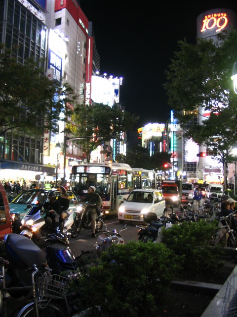 several motorcycles are parked along side a city street
