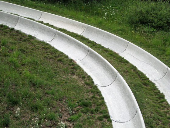 two street ramps with grassy grass at one end