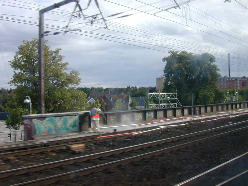 a rail road track with a train driving by it