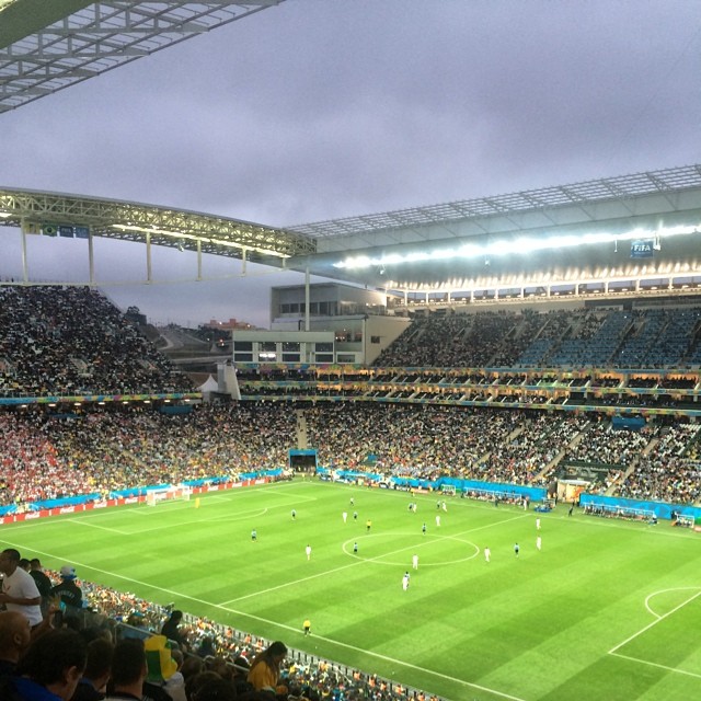 a soccer stadium with fans sitting around the tables