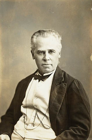 an old pograph of a man wearing a tuxedo