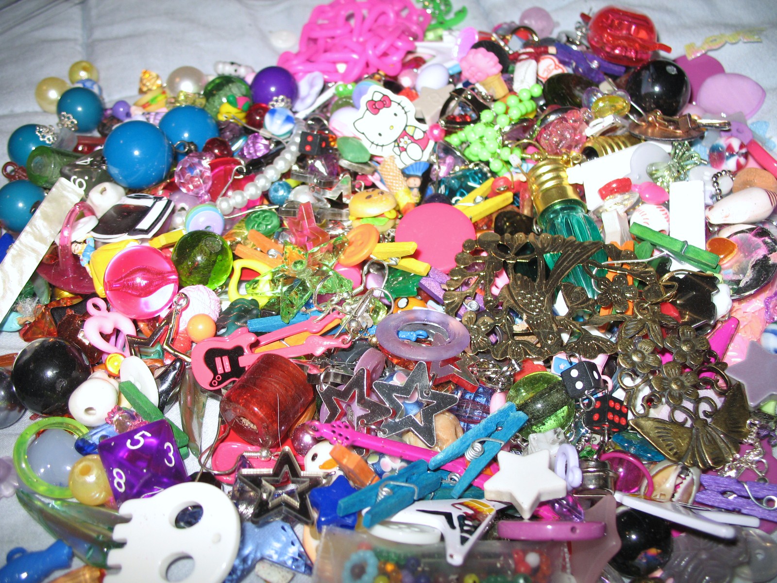 many different toys and jewelry all laying together