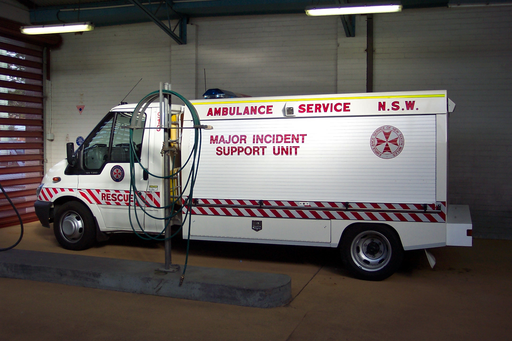 a ambulance truck parked in an enclosed area