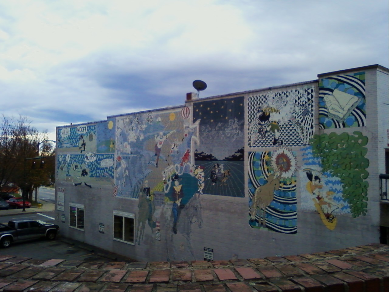 the building is covered with colorful murals all over it