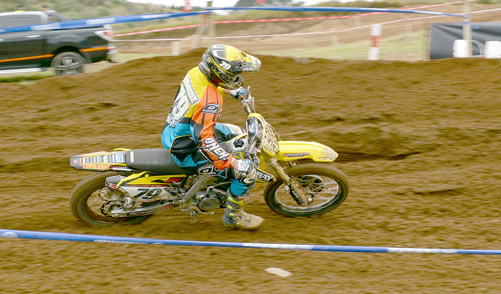person riding a dirt bike in a race on a course