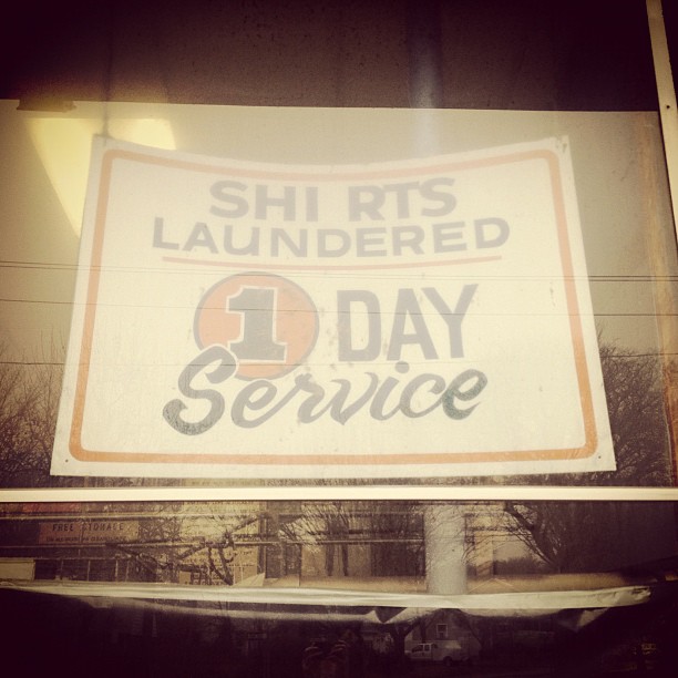 a sign stating the last day service for a laundry business
