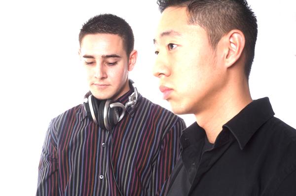 two men are wearing headphones in front of a white background
