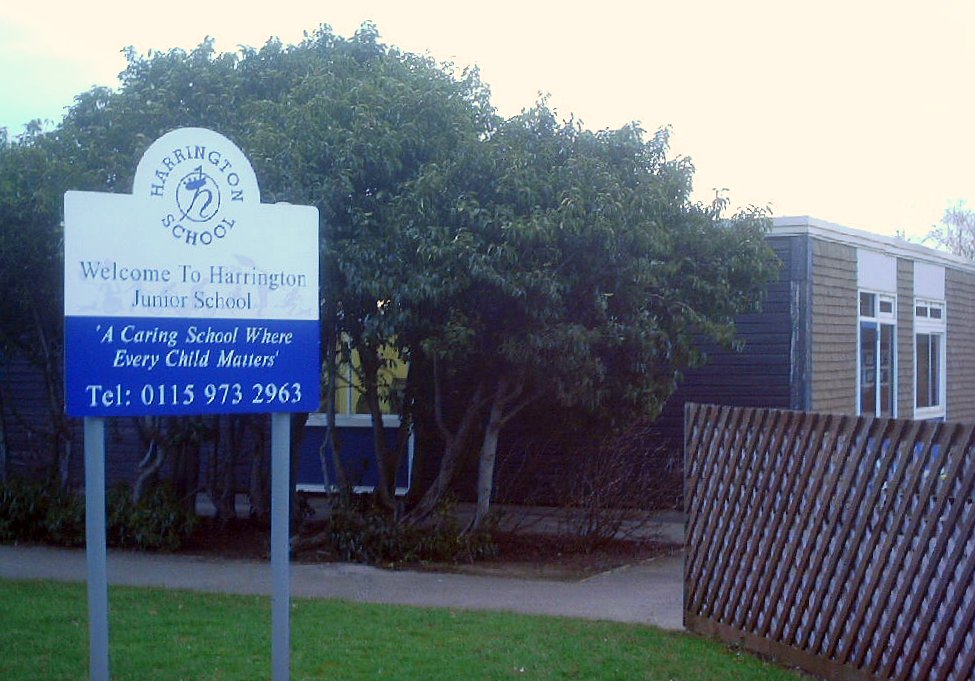 a school sign is shown in the yard