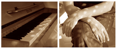 the man is sitting at the piano and it has his arm folded up