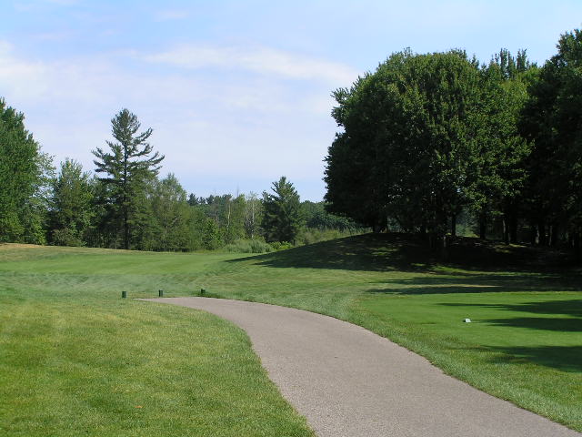 a dirt path winds across the golf course