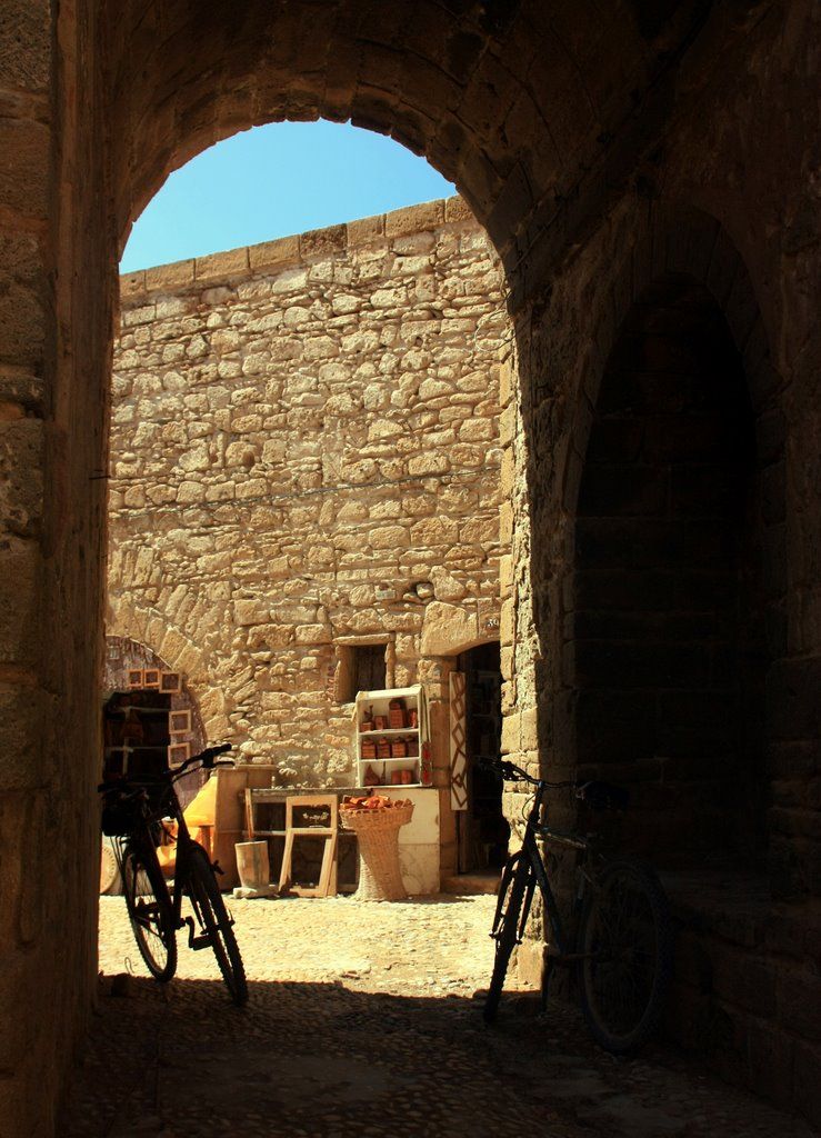a stone and brick building with bicycles parked inside