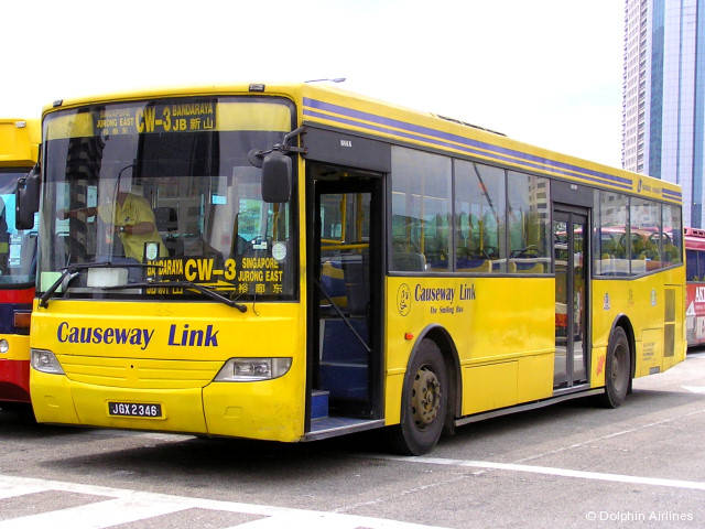 two yellow city buses with large windows on street
