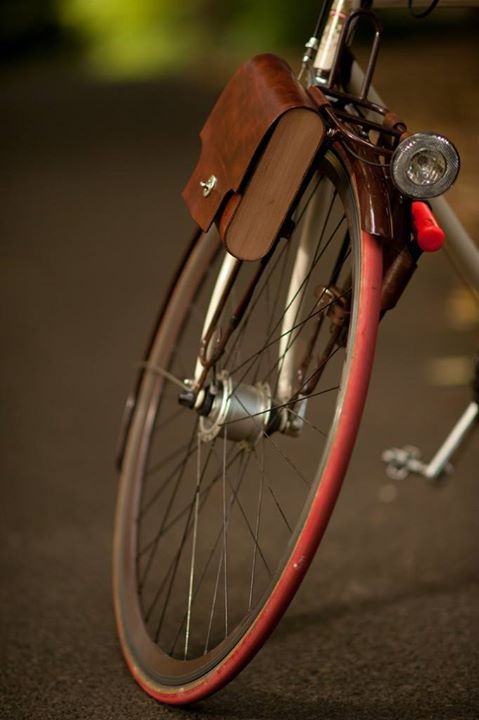 an old bicycle with a leather seat on it