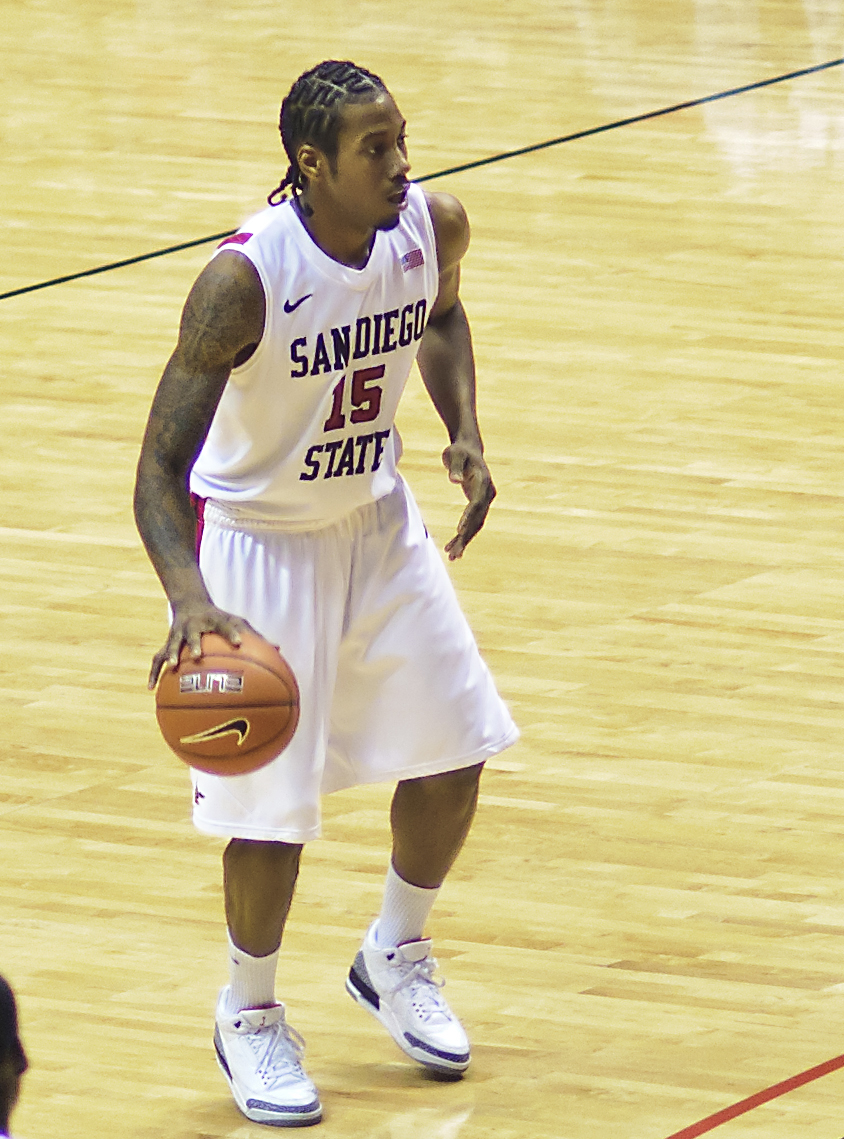 basketball player with a ball in his hand at the court