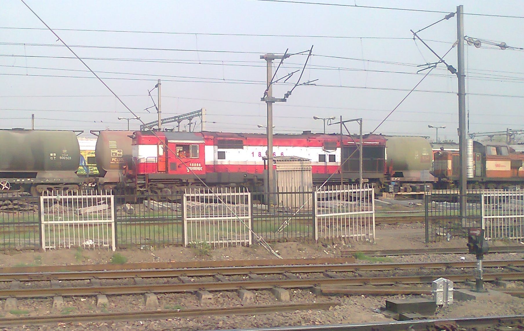 a train is on the track in the middle of an open field