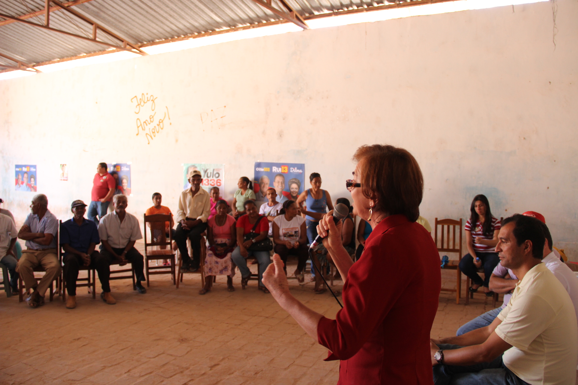 a woman giving a lecture to a room full of people