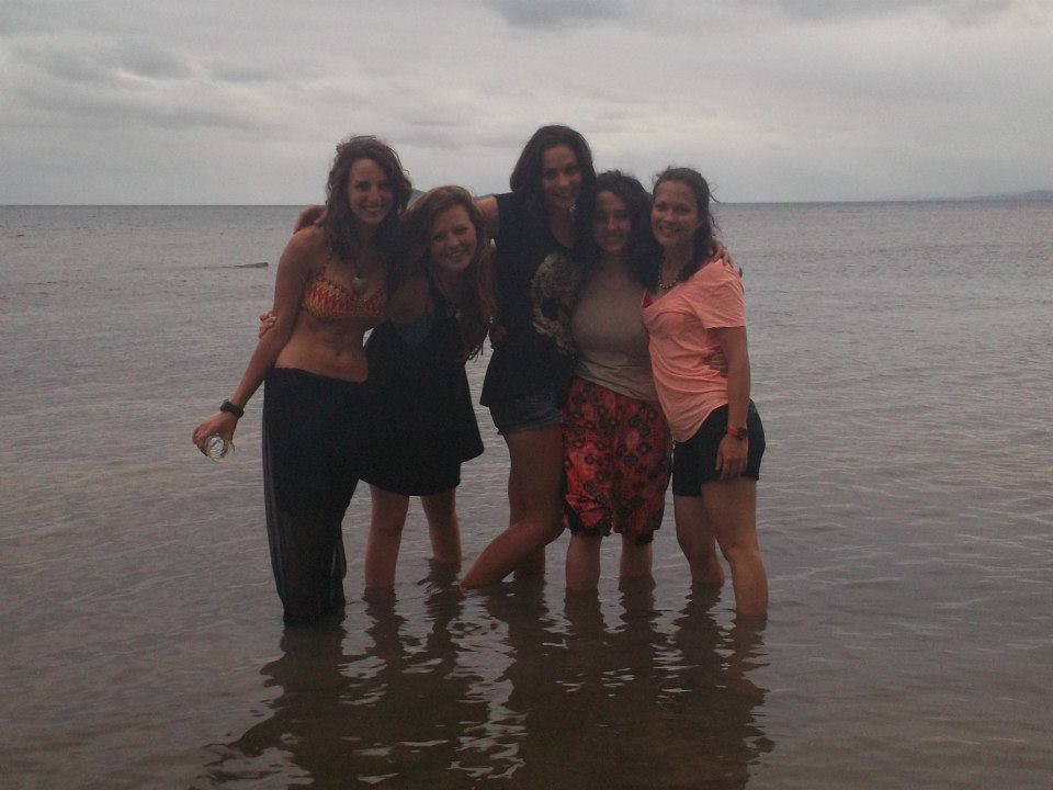 a group of girls are standing in shallow water