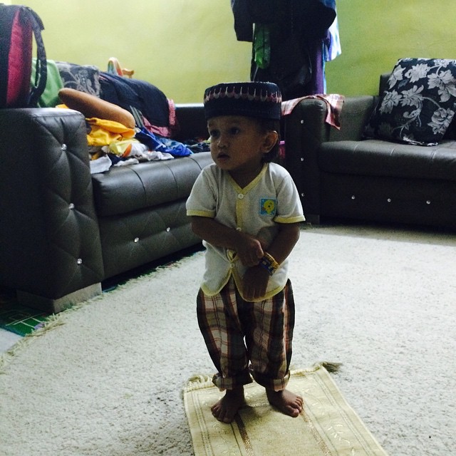 a child standing on the ground on a mat