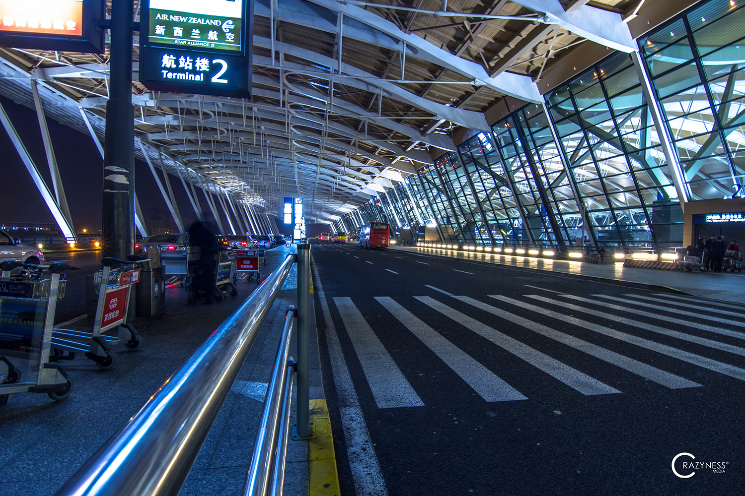 an airport terminal with people walking and luggage