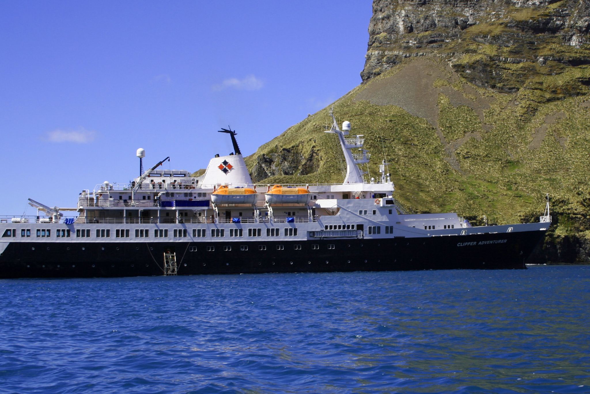 a cruise ship sits in the open ocean