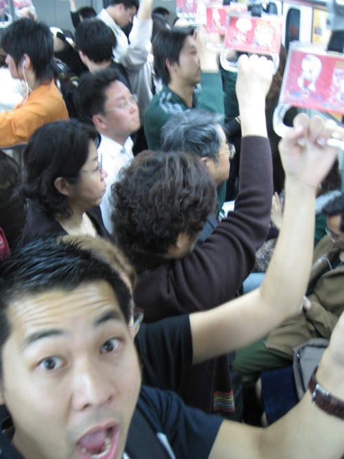 a group of people holding up cell phones taking pictures