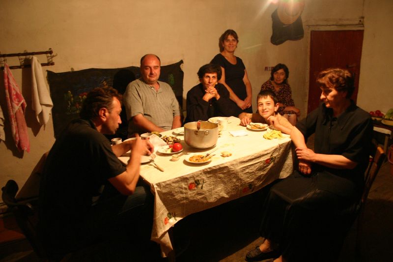 a large group of people that are sitting around a table