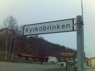 street sign in norwegian language at a rural intersection