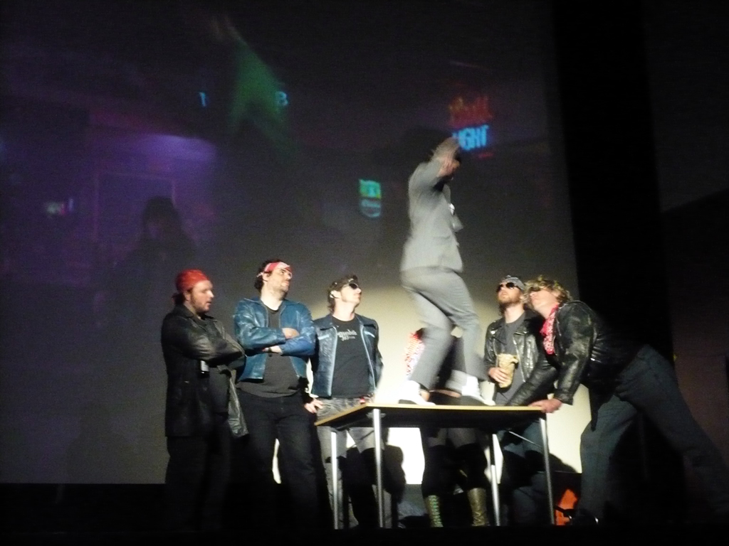 a group of men standing on top of a stage