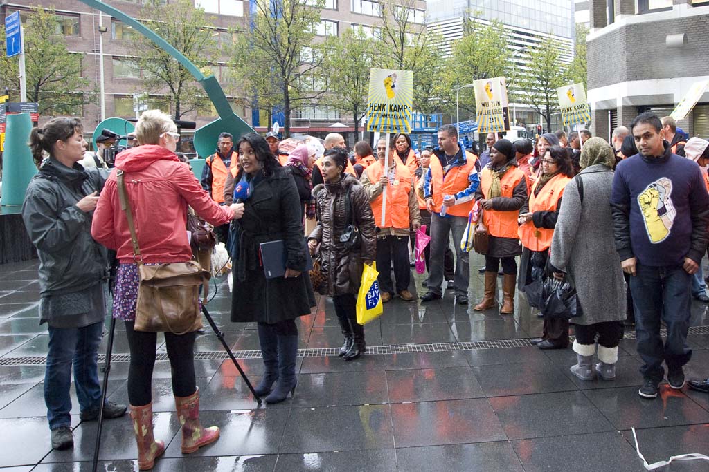 several people are standing in the rain