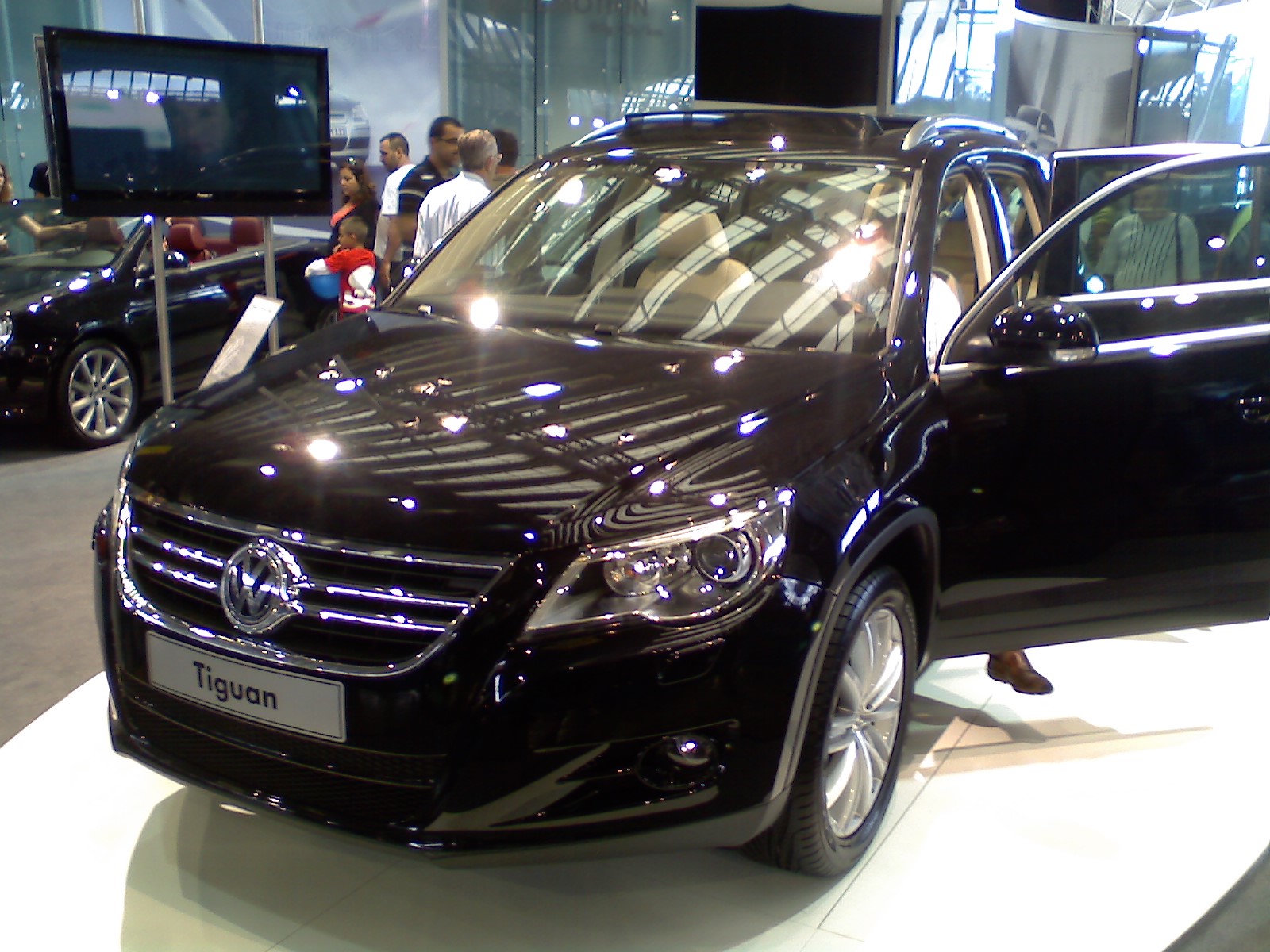 a black car with large hood sitting on display