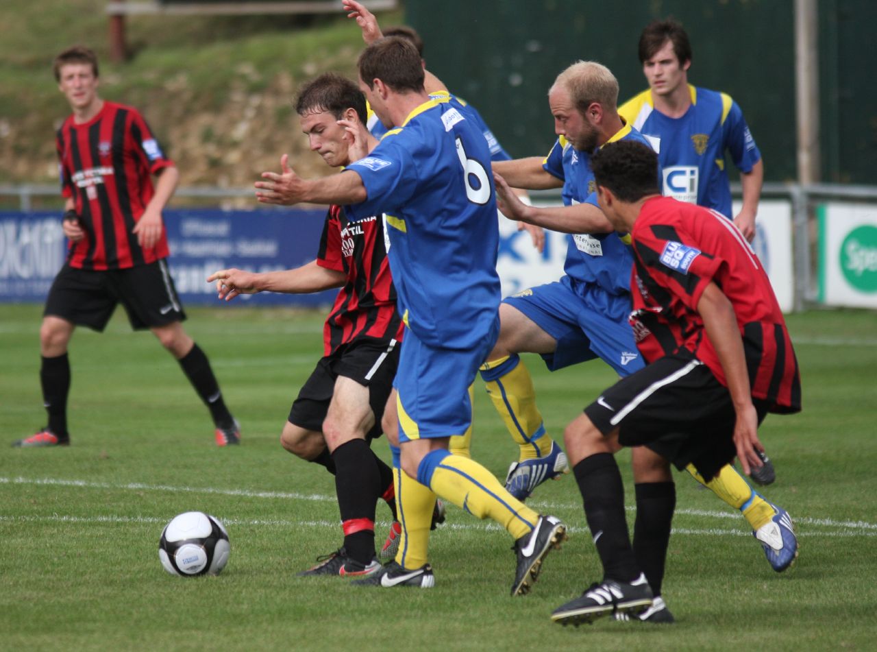 a soccer match going on with the opposing team trying to get the ball