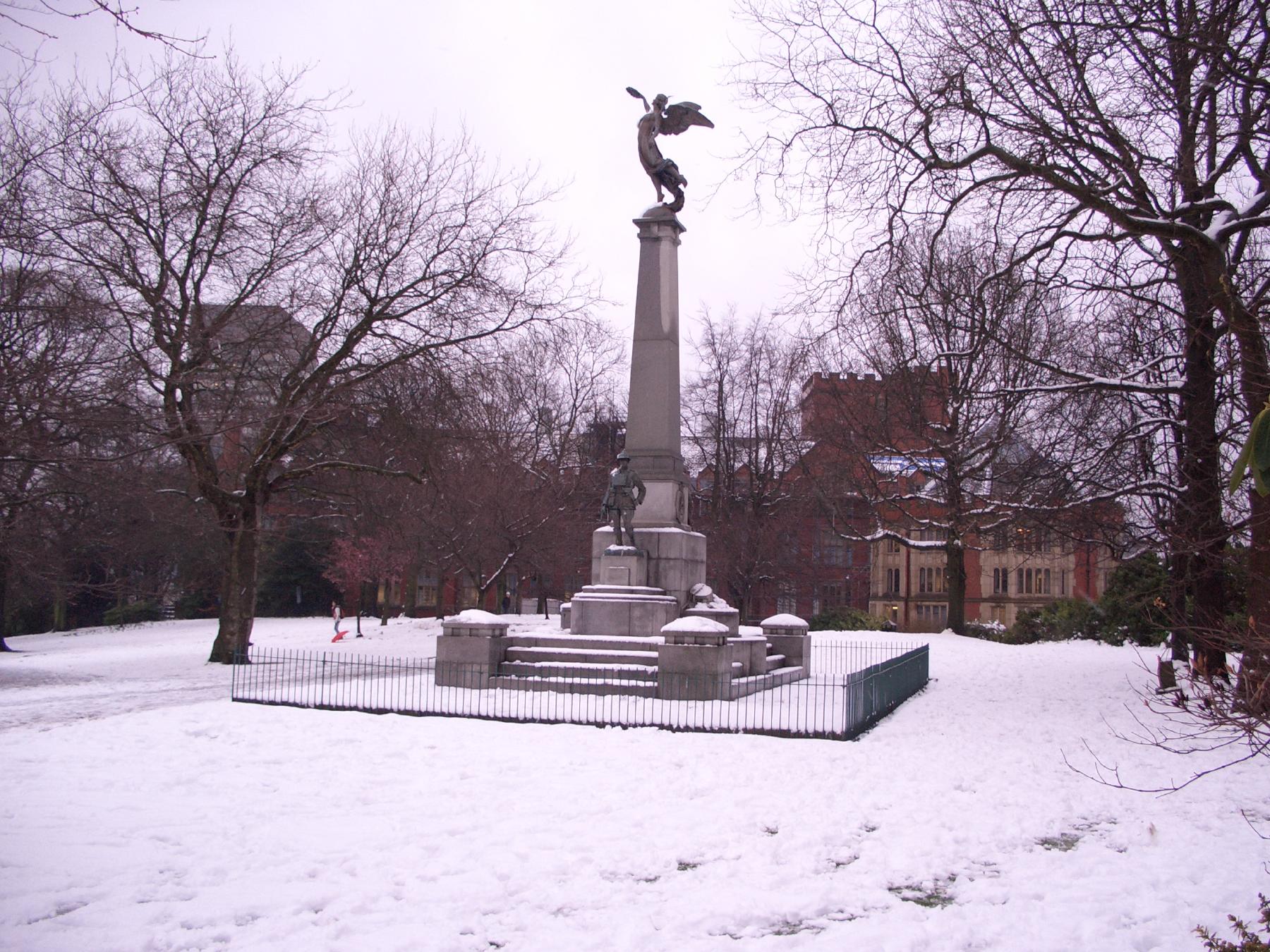 a snowy monument in the middle of a park