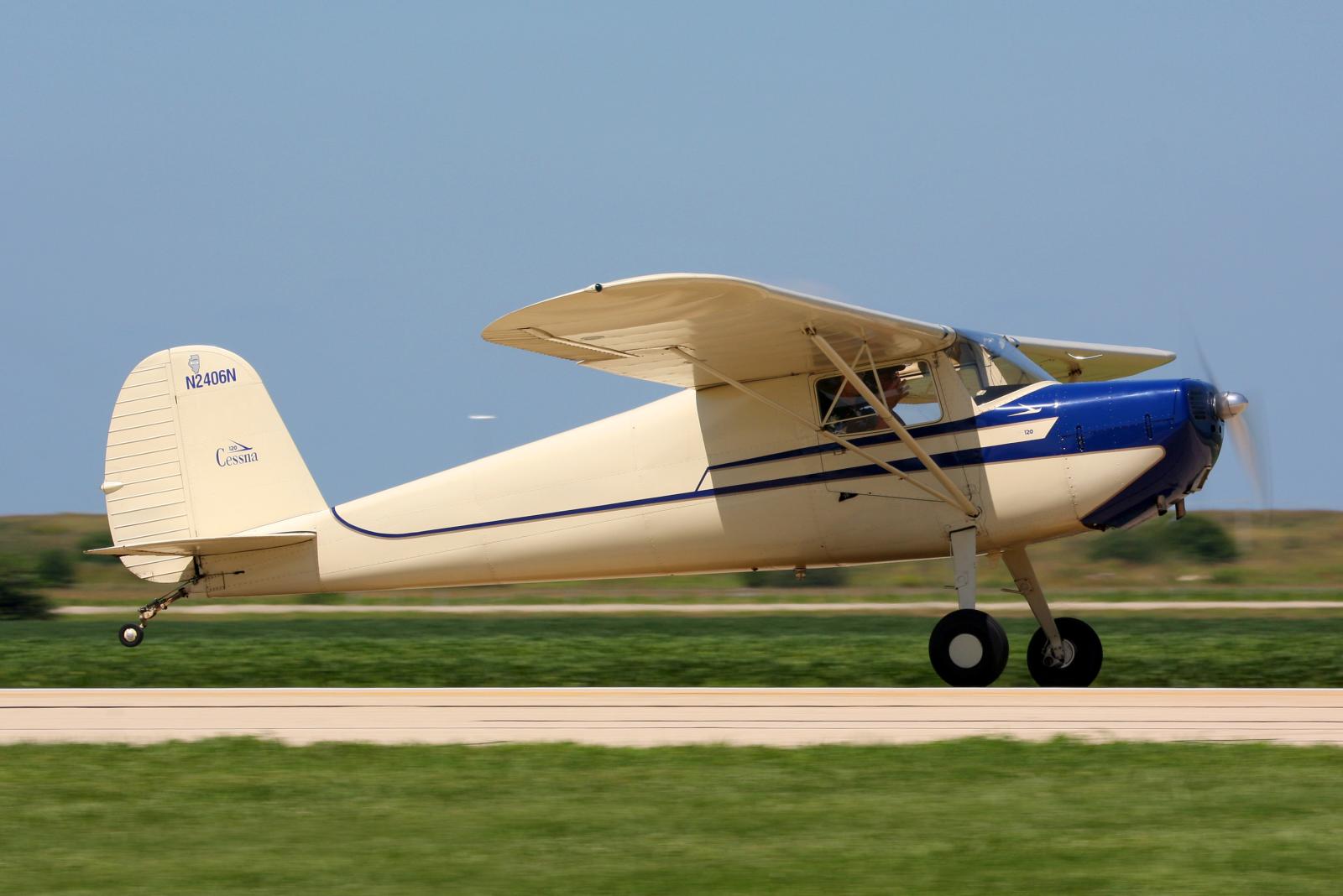 a small plane with two front wheels on it is landing