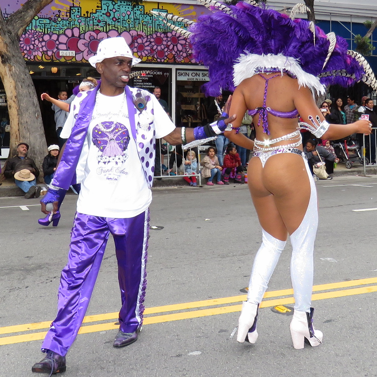 two men wearing fancy purple costumes on the street