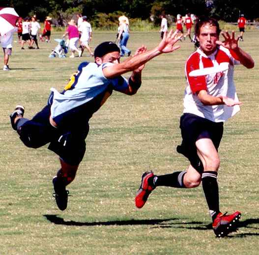 two men running towards each other in a soccer match