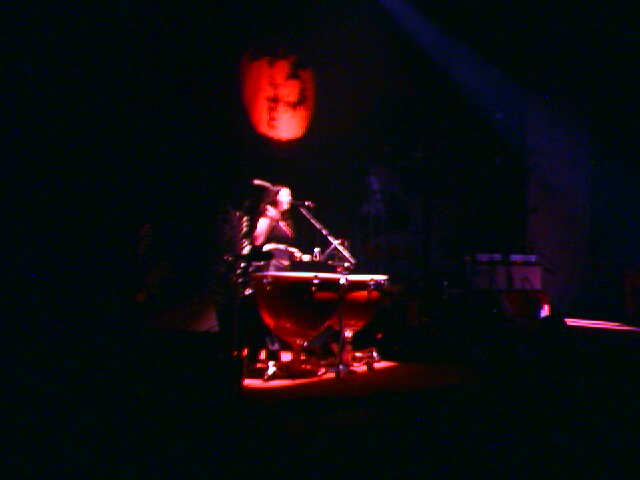 a drummer plays drums in a dark stage