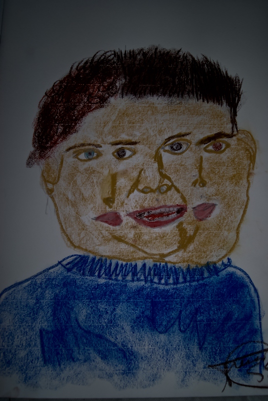 a colored drawing of a person with dark hair and blue shirt