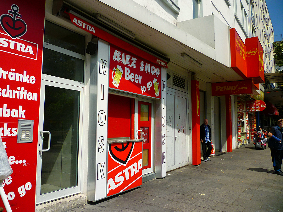 a number of shops with signs on the door